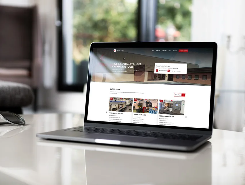 The Percy Martin website shown on a laptop.